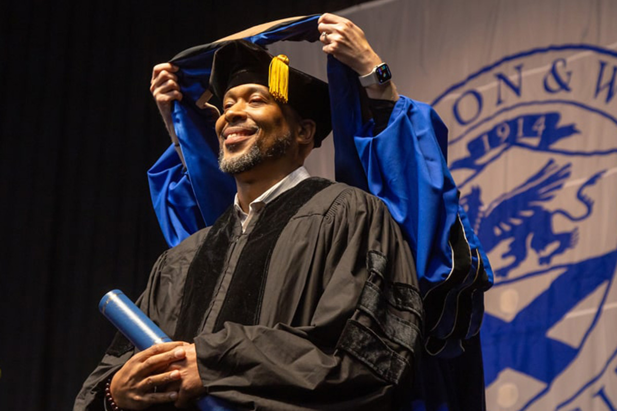 Photo of two students at commencement. 